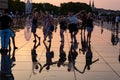 Friends having fun walking in the water mirror fountain at Place de la Bourse in Bordeaux, Aquitaine, France