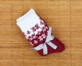 Bordeaux and white socks with a festive bow, isolated on a wooden background.