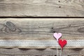 Border of burlap with white lace and decorative hearts on old wooden table. Design for border or background. Place for text. Royalty Free Stock Photo