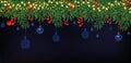 Border with Christmas green branches, holly red berries on dark blue background. Christmas blue balls hanging on tree Royalty Free Stock Photo