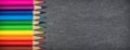 Border of colored pencils on black background. School concept. Royalty Free Stock Photo