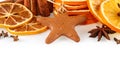 Border of dried oranges, lemons, mandarins, star anise, cinnamon sticks and gingerbread, isolated on white Royalty Free Stock Photo