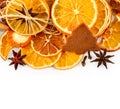 Border of dried oranges, lemons, mandarins, star anise, cinnamon sticks and gingerbread, isolated on white Royalty Free Stock Photo