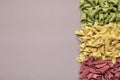 Border of dried colourful pasta on grey background Royalty Free Stock Photo