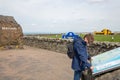 Border between England and Scotland with rock and reading woman