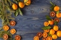 Border, frame from Christmas tree fir branches, dried orange fruit slice on old wooden desk table background. Big copyspace for h Royalty Free Stock Photo