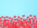 Border frame of red hearth-shape sprinkle on blue background Royalty Free Stock Photo