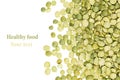 Border of green dry purified peas closeup with copy space on white background. Royalty Free Stock Photo