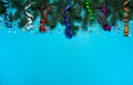 The border is made of spruce branches, colorful streamers and confetti on a light blue background. Royalty Free Stock Photo