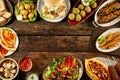 Border of Mediterranean dishes and bread on table