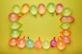 Border of multicolored water balloons, flat lay