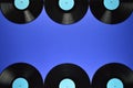 Border of old black vinyl records on blue background Royalty Free Stock Photo