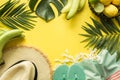 Border of outfit beach female accessories. Tropical vacations, straw sun hat, towel, monstera leaves on yellow. Summer concept Royalty Free Stock Photo
