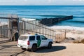 Border Patrol Vehicle Near U.S./Mexico Border Wall at Pacific Ocean Royalty Free Stock Photo