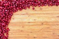 Border of pomegranate seed on a wood background