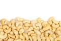 Border of raw, organic, whole cashew nut kernels over white