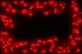 A border of red holly berry christmas lights, on a dark woodern Royalty Free Stock Photo