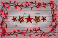 A border of red holly berry christmas lights, and red stars, on Royalty Free Stock Photo