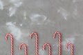 Border of red and white candy canes on grey background. Christmas concert Royalty Free Stock Photo