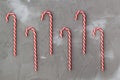 Border of red and white candy canes on grey background. Christmas concert Royalty Free Stock Photo