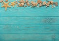 Border with rope, stones, sea shells and starfish on a turquoise Royalty Free Stock Photo