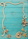 Border with rope, stones, sea shells and starfish on a turquoise Royalty Free Stock Photo