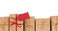 Border row of brown paper parcels, one unique with red ribbon bow and gift tag