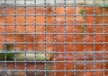 border separation fence and the brick wall of the penitentiary out of focus in background Royalty Free Stock Photo