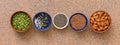 Border various seeds in a bowl in a row on a brown stone background. Sesame, flax, chia, pumpkin, almonds. Top view, flat lay,