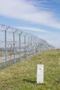 Border fence between Rastina Serbia & Bacsszentgyorgy Hungary with a boundary marker