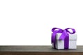 Border with white gift box with purple ribbon bow Royalty Free Stock Photo