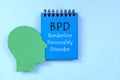 Borderline personality disorder or BPD diagnosis written on notepad in blue background.