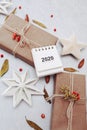 Winter flat lay with natural branches. leaves and presents on light background