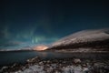 Borealis aurora sweeps over a large lake on a cloudless night in Kilpisjarvi, Lapland, Finland. aurora polaris in green dances