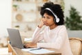 Bored African American Teen Girl Sitting At Laptop At Home Royalty Free Stock Photo