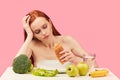 Bored apathetic woman eats croissant staring off into space ignoring raw fruits Royalty Free Stock Photo