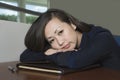 Bored Asian Businesswoman With Head On Desk