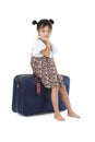 Bored Asian girl sitting luggage