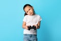 Bored asian kid playing video game using joystick Royalty Free Stock Photo