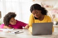 Bored Black Girl Demanding Attention From Her Busy Mom Working At Home Royalty Free Stock Photo