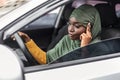 Bored Black Muslim Woman In Hijab Driving Car In Traffic Jam