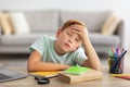 Bored boy doing homework in front of laptop at home Royalty Free Stock Photo