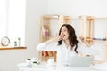 Bored business people: woman sitting at desk with closed eyes and yawning. Young caucasian business woman at her office. Royalty Free Stock Photo