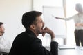 Bored businessman feel tired sleepy yawning during corporate presentation meeting