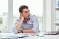 Bored businessman with laptop and papers at office Royalty Free Stock Photo