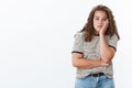 Bored careless plump young indifferent girl blue eyes curly hairstyle facepalm lean face hand look annoyed not