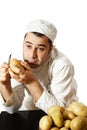 Bored chef peeling potatoes Royalty Free Stock Photo