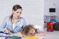 Bored child at desk Royalty Free Stock Photo