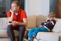 Bored child and father is watching TV Royalty Free Stock Photo