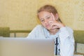 Bored child girl looks at computer. distance learning uninteresting. Royalty Free Stock Photo